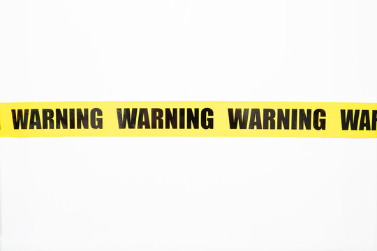 Yellow Warning Tape Isolated And Cutout On White Background. Risk And Accident Concept