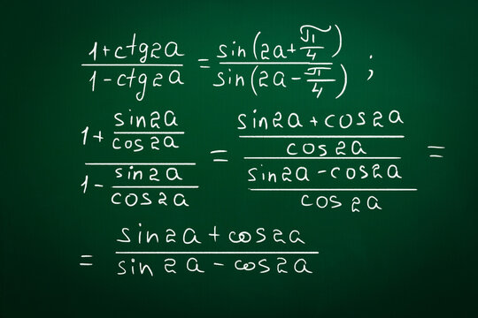 Different trigonometric identities written on green chalkboard