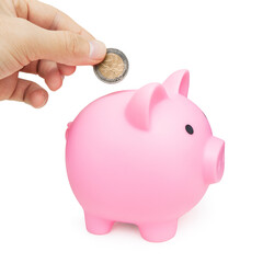 Hand with two euro coin and pink piggy bank. Isolated with clipping path. Savings and financial...