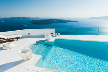 White architecture on Santorini island, Greece. Luxury swimming pool with sea view. Travel and...