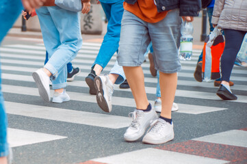 People crossing street in city, closeup view