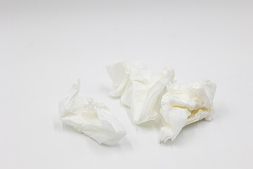 Several crumpled white used white paper napkins isolated on a white background