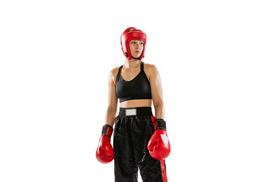 One female boxer in boxing gloves and helmet posing isolated on white studio background. Sport, competition, hobby, results, success concept