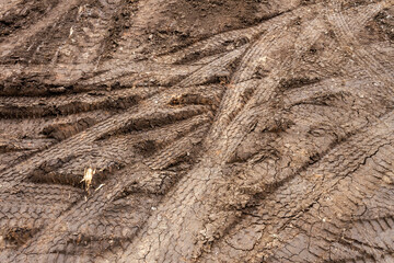 Different tire tracks on dry clay soil