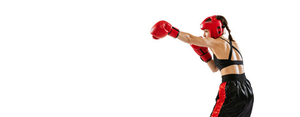 One female boxer in boxing gloves and helmet training isolated on white studio background. Sport,...