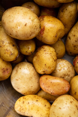 Close up of fresh washed potato ready for cooking in bowl