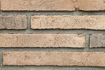 Textured brown brick wall, stone texture. Decorative tiles for wall decoration. Background, brown, decorative brick. Loft-style decor.