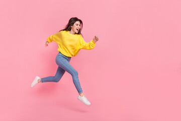 Fototapeta na wymiar Full size profile side photo of young excited lady hurry movement jump look empty space isolated over pink color background