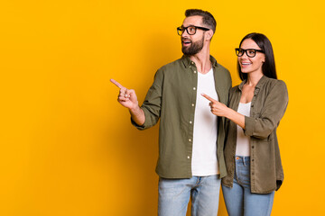 Photo of impressed millennial brunette people index look promo wear glasses shirt isolated on yellow color background - obrazy, fototapety, plakaty