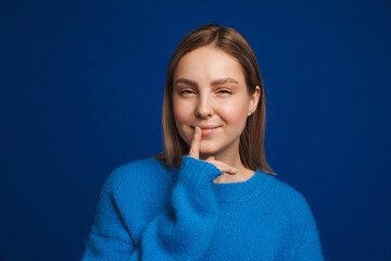 Fototapeta premium Young white happy woman wearing sweater looking at camera
