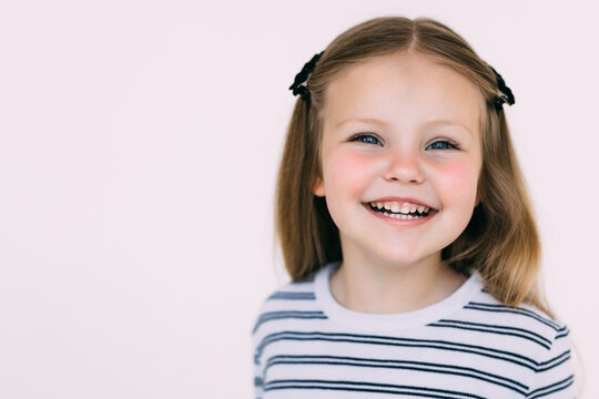 Portrait of a happy laughing child girl isolated on white background