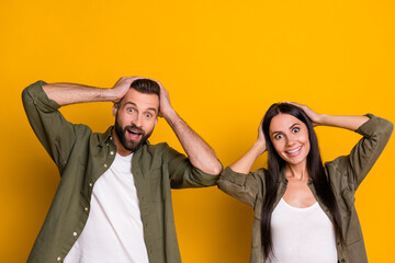 Photo of young spouses hands touch head reaction omg wow news unbelievable isolated over yellow...