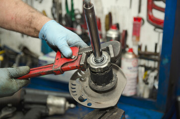 Auto mechanic working on car engine in mechanics garage. Repair service. authentic close-up shot 