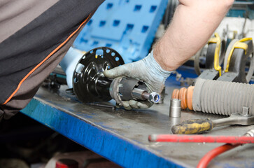 Auto mechanic working on car engine in mechanics garage. Repair service. authentic close-up shot 