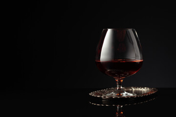 Snifter of brandy on a on a silver tray.