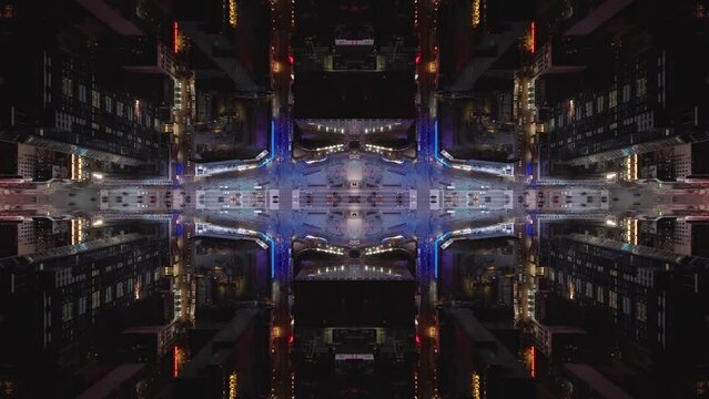 Birds eye shot of colourfully lit streets of metropolis at night. Abstract computer effect digital composed footage.