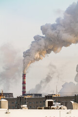 industrial chimneys with heavy white smoke causing air pollution problem	