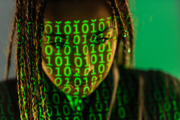 African american woman with projection of binary code on grey background.