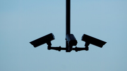 Silhoutte images of security camera or cctv video surveilance at outdoor which is technology system...