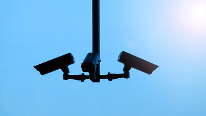 Silhoutte images of security camera or cctv video surveilance at outdoor which is technology system...