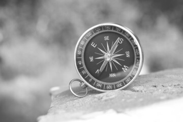 Classic navigation compass on natural background as symbol of tourism with compass, travel with compass and outdoor activities with compass