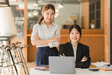 Portrait of Asian young female working on laptop at office