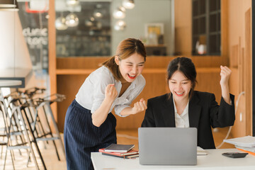 Portrait of Asian young female working on laptop at office