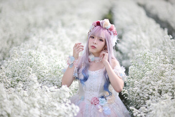 Fototapeta na wymiar Beautiful young woman with white lolita dress with flowers garden Japanese fashion