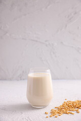 Soy milk in glass and soy bean isolated in white background