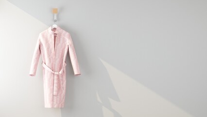 pink bathrobe hanging on the wall