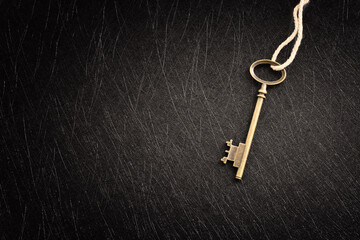Golden key over dark background, wisdom, wealth, and spiritual concept