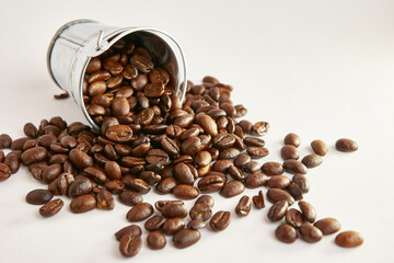Metal bucket with roasted coffee beans.