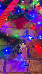 Christmas tree decoration over a brick chimney