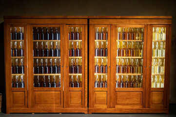 Different ages and colours of strong alcoholic apple drink calvados in Normandy, Calvados region, France