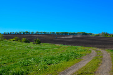 tractor in the field sows wheat