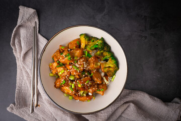Top view, Delicious sweet chopping chicken rice, sesame seeds and sliced spring onions, broccoli, vegetables with chopsticks. Asian food, Japanese food copy space for your text
