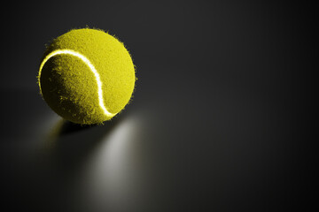 Tennis ball with glow effect on dark background with copy space, 3d rendering