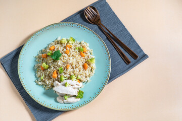 Healthy food fried rice with chicken breast have vegetable on wood table.