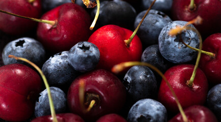 cherries and blueberries mixed together. berry background.