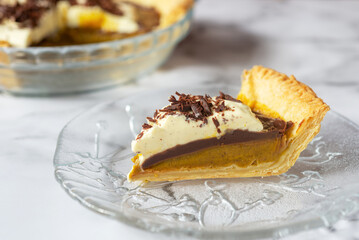 homemade chocolate pumpkin pie on marble table background.