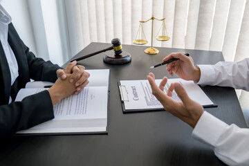  Judge gavel with Justice lawyers having team meeting at law firm background. Concepts of Law and...
