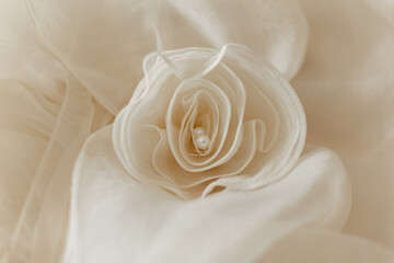 beige rose on a dress with pearls on a bride's wedding dress