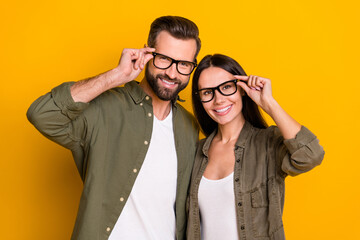 Photo of young cheerful couple intelligent eyewear oculist look vision isolated over yellow color...