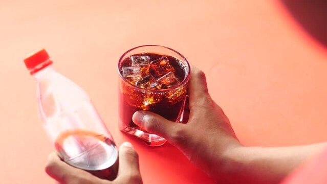  person holding a glass of soft drinks 