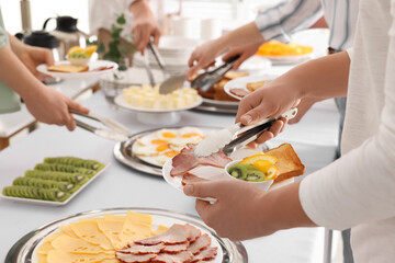 Obraz na płótnie Canvas People taking food during breakfast, closeup. Buffet service