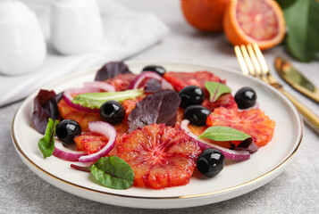 Plate of delicious sicilian orange salad on grey table, closeup