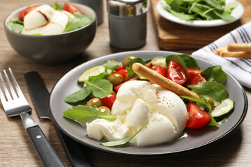 Delicious burrata salad served on wooden table