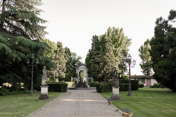beautiful alley in the park with statues in italy