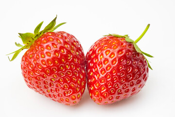 Two ripe strawberries on a white background. Red strawberry macro photo