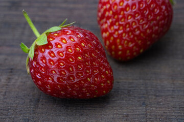 Beautiful ripe strawberry on a wooden background.